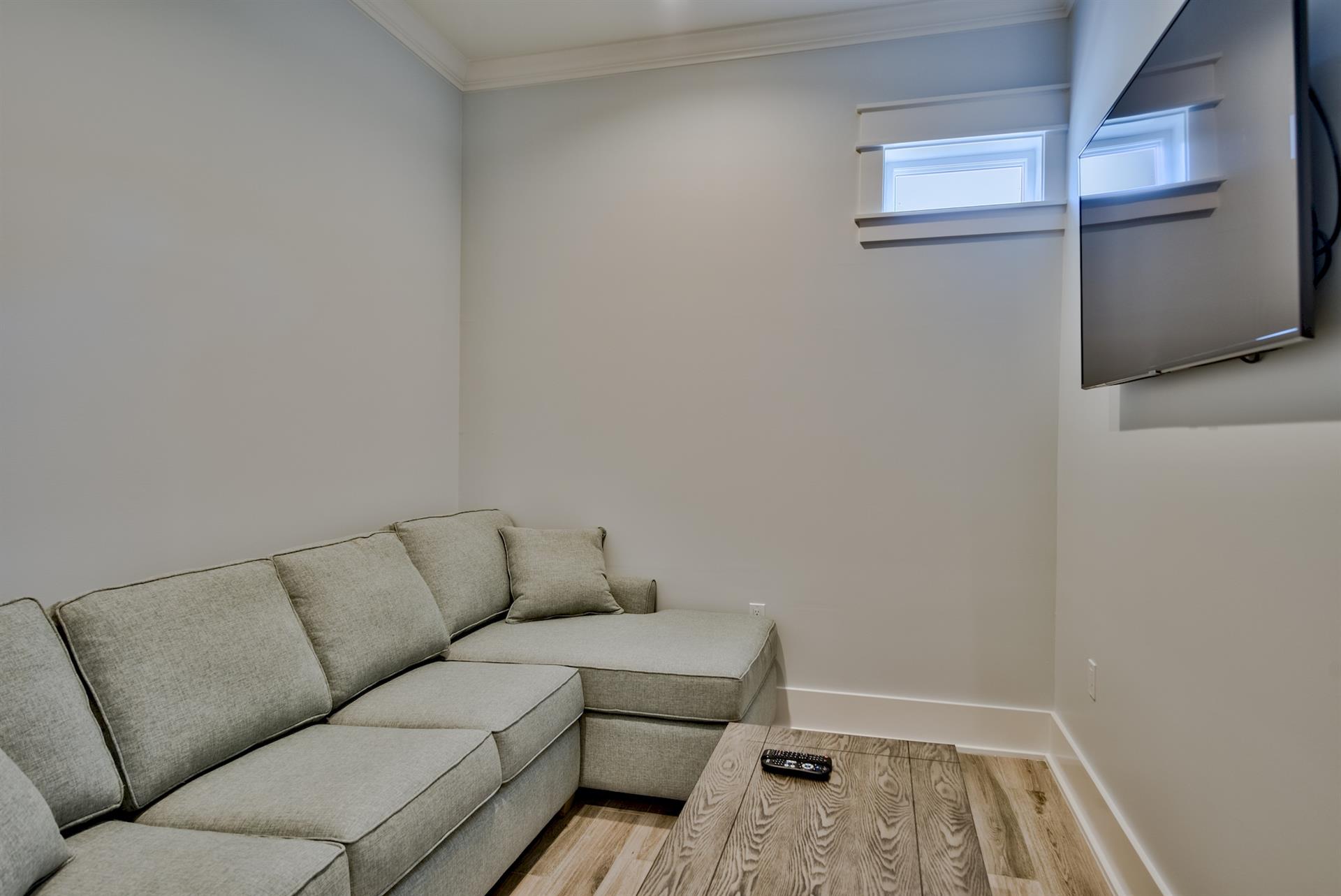 2nd floor sitting area with sofa sleeper and TV