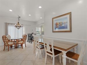 Dining area with multiple tables and breakfast bar seating