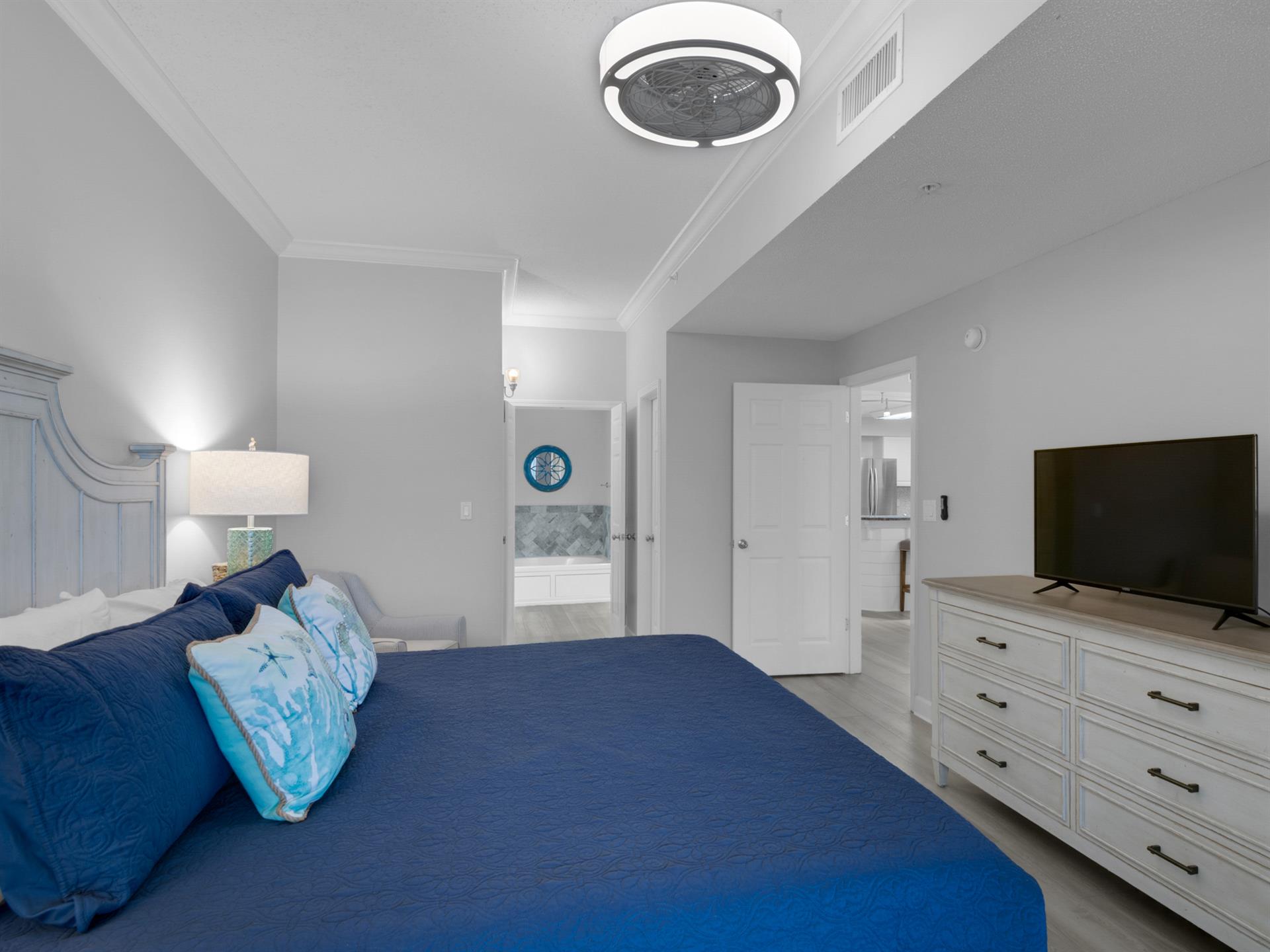 Primary bedroom TV and private full bath