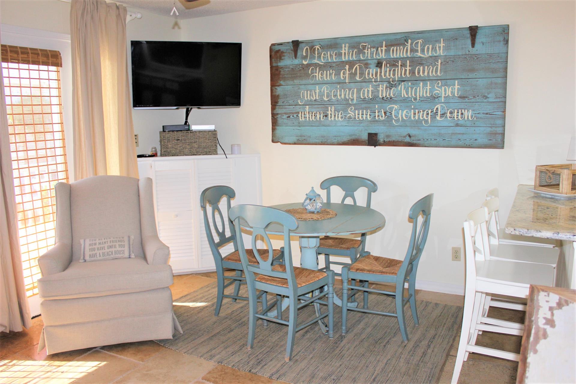 Large flat screen TV and dining area