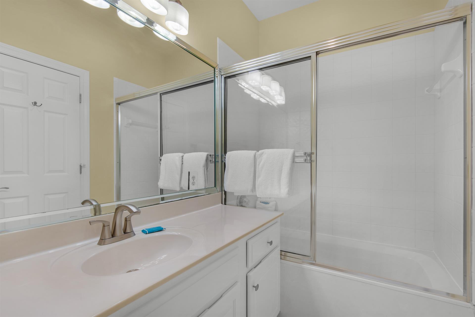 Guest Bathroom with Tub Shower Combo in Hallway