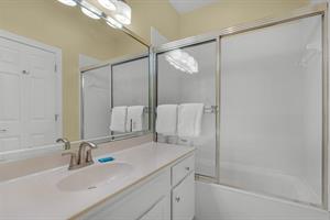 Guest Bathroom with Tub Shower Combo in Hallway